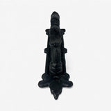 Cast iron door handle finial top view showing black weathered metal finish