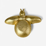 Close-up of gold bee trinket dish showing textured surface finish and cast iron craftsmanship