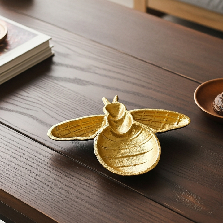 Gold cast iron bee trinket dish overhead view showing detailed molded body and wings