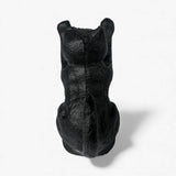 Front view of black cast iron cat door wedge sitting pose with ears visible textured surface detail