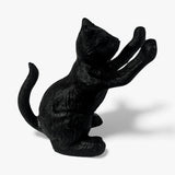 Charcoal finish cast iron cat figurine with raised paws, playful sitting position from side angle