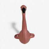 Pink cast iron flamingo hook with dual mounting holes, frontal view