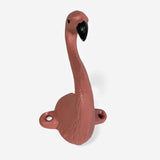 Pink cast iron flamingo wall hook in curved pose with mounting hardware visible