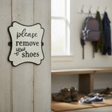 Cast iron remove shoes wall sign, white with black border, entryway decor plaque