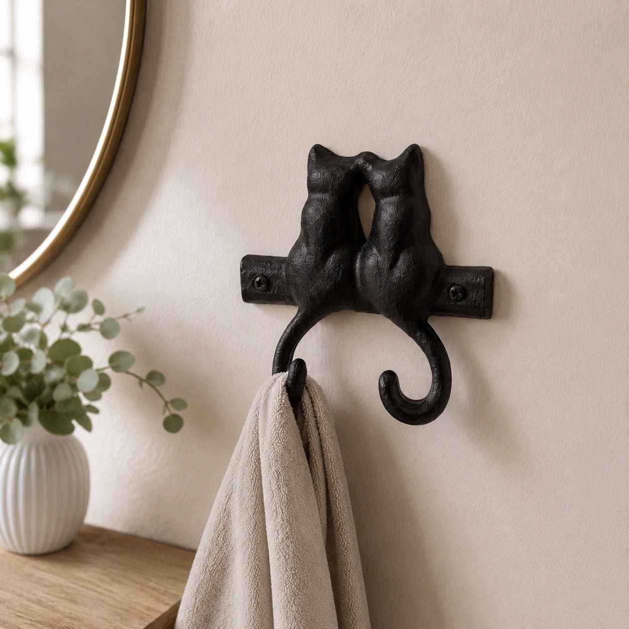 Black cast iron kissing cats double wall hook holding a towel in a bathroom, SKU GB78064